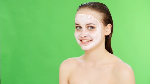 Woman with cosmetic face mask smiling — Stock Video