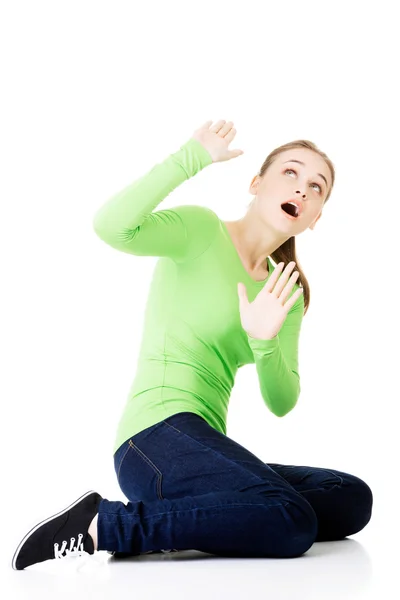 Scared young woman afraid of something above her — Stock Photo, Image