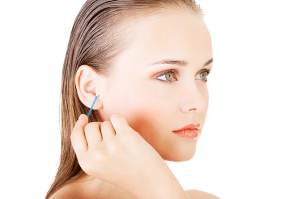 Woman face closeup while cleaning up an ear with a swab — Stock Photo, Image