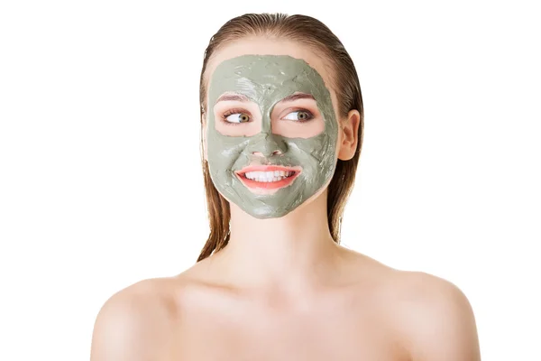 Beautiful woman with clay facial mask, isolated on white — Stock Photo, Image