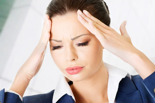 Businesswoman with a headache — Stock Photo, Image