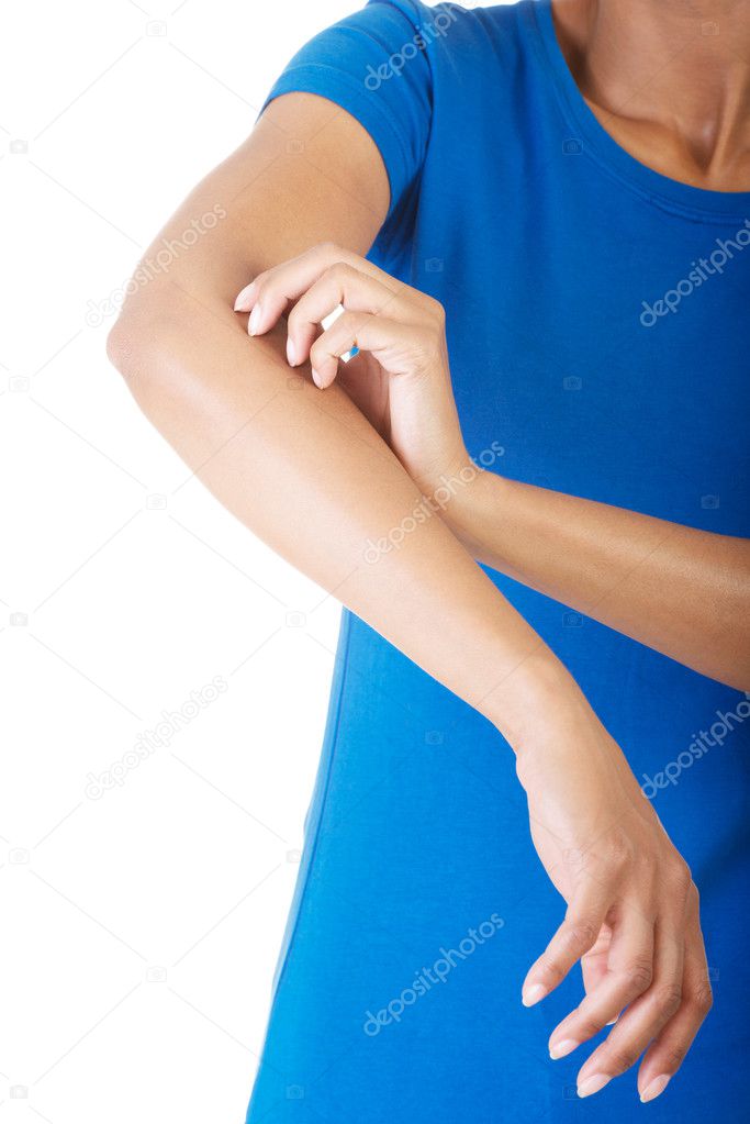 Young woman scratching her self.