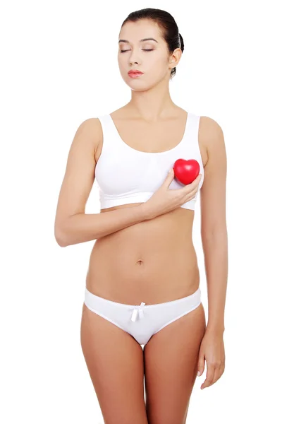Happy Fit female with red heart shaped toy — Stock Photo, Image