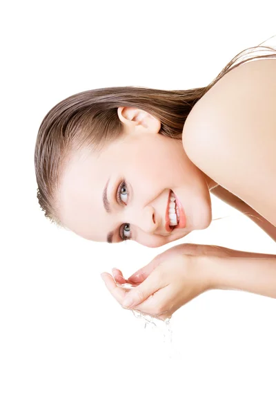 Mujer joven lavándose la cara con agua clara — Foto de Stock