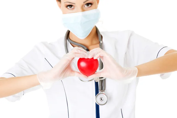 Young nurse with heart in her hand — Stock Photo, Image