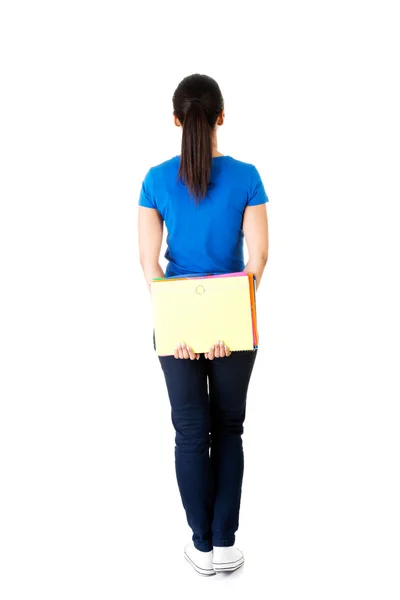 Vista posterior de una joven estudiante sosteniendo un cuaderno . —  Fotos de Stock