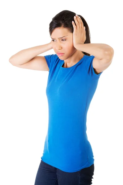 Closeup of frustrated young woman holding her ears — Stock Photo, Image