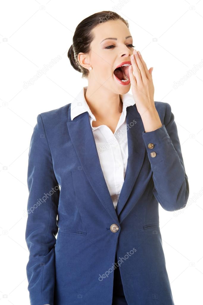 Tired business woman in a suit ,isolated over white background