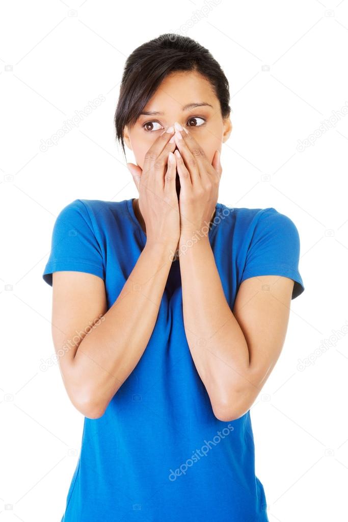 Young scared woman covering the mouth