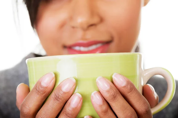 Young woman drinking something from big mug — Stock Photo, Image