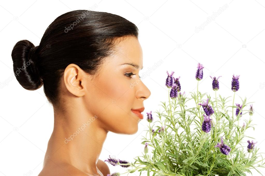 Beautiful girl smell lavender flowers