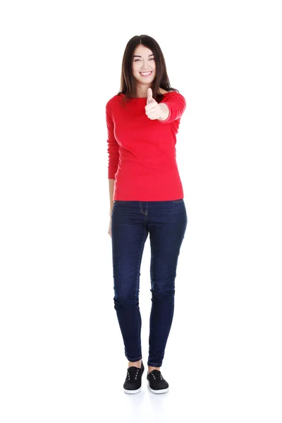 Young woman in casual clothes gesturing thumbs up. — Stock Photo, Image