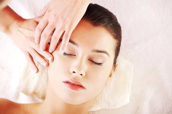 Beautiful young relaxed woman enjoy receiving face massage — Stock Photo, Image
