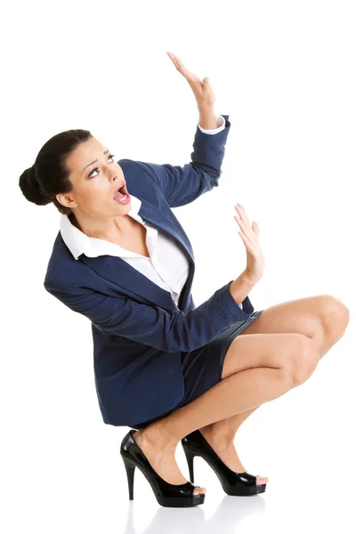 Scared businesswoman defending herself Stock Image