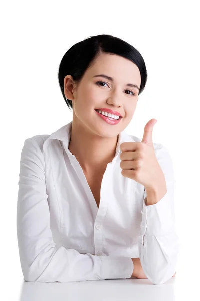 Young woman at the desk gesturing OK — Stock Photo, Image