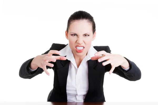 Angry businesswoman at the desk — Stok fotoğraf