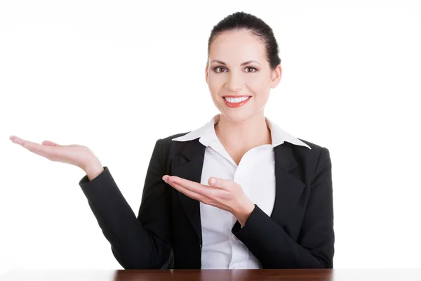 Business woman showing copy space on her palm — Stock Photo, Image