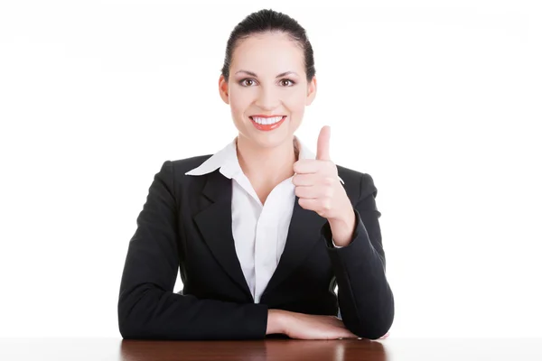 Young woman at the desk gesturing OK — Stock Photo, Image