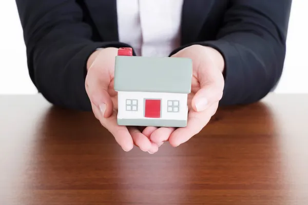 Businesswoman with house model — Stock Photo, Image