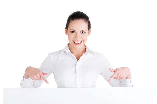 Attractive businesswoman holding blank board. — Stock Photo, Image