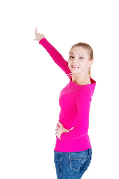 Happy , excited young woman pointing on copy space — Stock Photo, Image