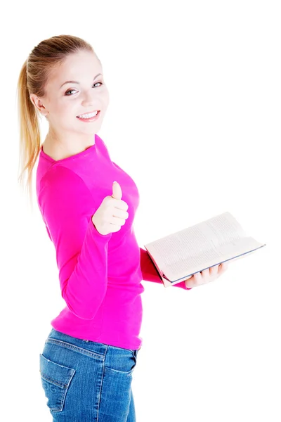 Jovem estudante atraente com livro gesticulando OK — Fotografia de Stock
