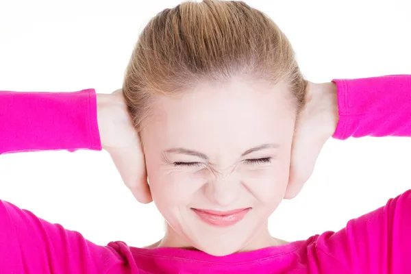 Closeup of frustrated young woman holding her ears. — Stock Photo, Image