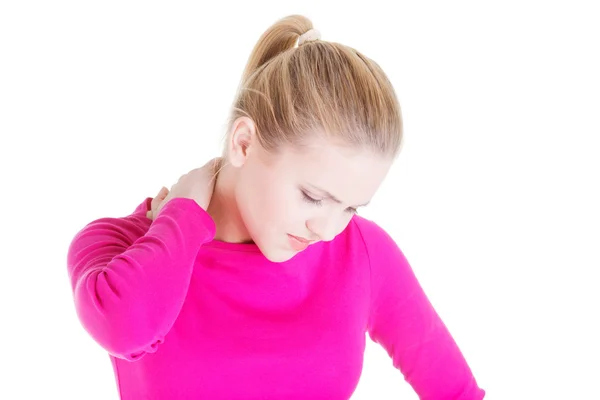 Oung woman holding hand on her neck. — Stock Photo, Image