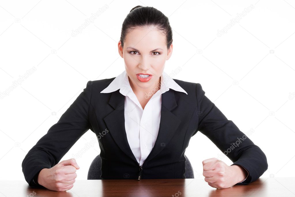 Angry businesswoman at the desk