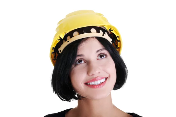 Confident female worker in helmet looking up — Stock Photo, Image