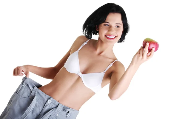 Young woman showing how much weight did she lost. — Stock Photo, Image