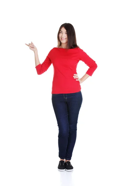 Happy woman pointing on copy space — Stock Photo, Image