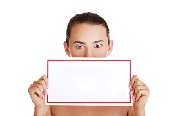 Shocked woman holding blank board — Stock Photo, Image