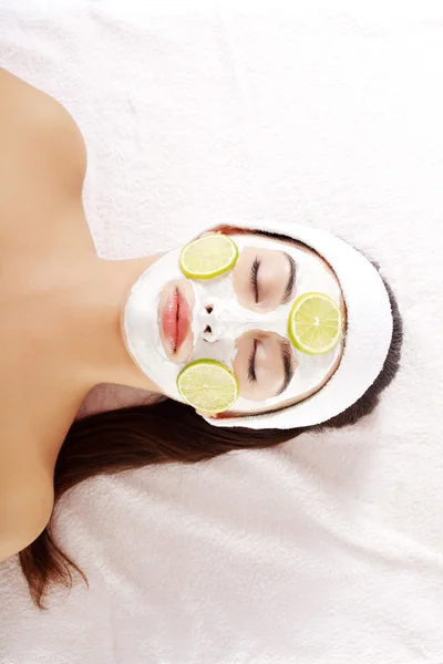 Attractive young woman with fruit mask on a face — Stock Photo, Image