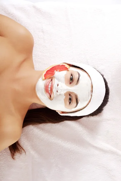 Attractive young woman with fruit mask on a face — Stock Photo, Image