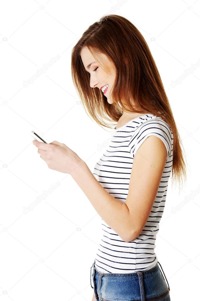 Young smiling caucasian tenn using cell phone