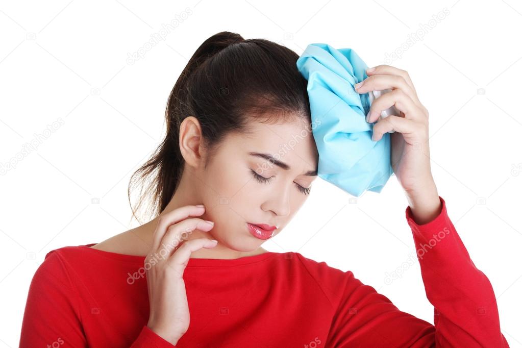 Woman with ice bag for headaches and migraines