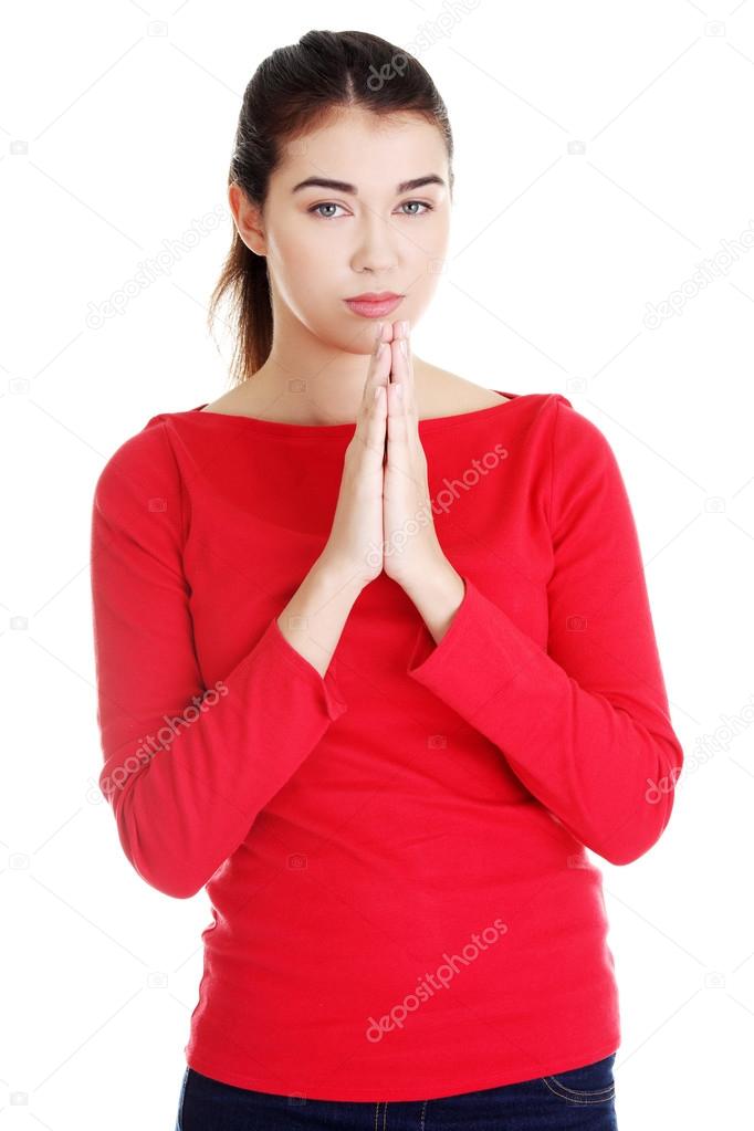 Portrait of a young caucasian woman praying