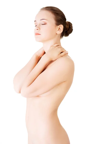 魅力的な裸の女性が彼女の首に触れます。フロント ビュー. — ストック写真