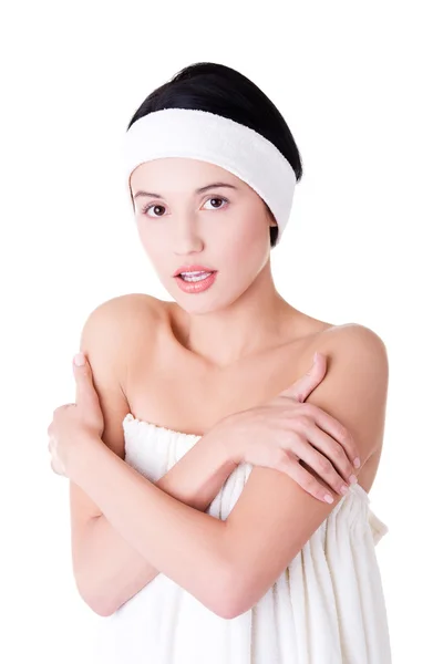 Attractive woman wrapped in white towel wth headband. — Stock Photo, Image