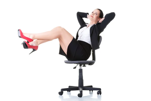 Business woman sitting on a chair with legs up. — Stock Photo, Image