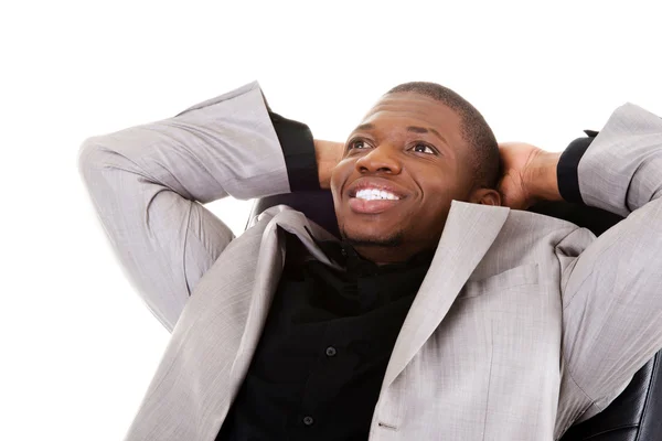 Handsome businessman sitting on a chair smiling. — Stock Photo, Image