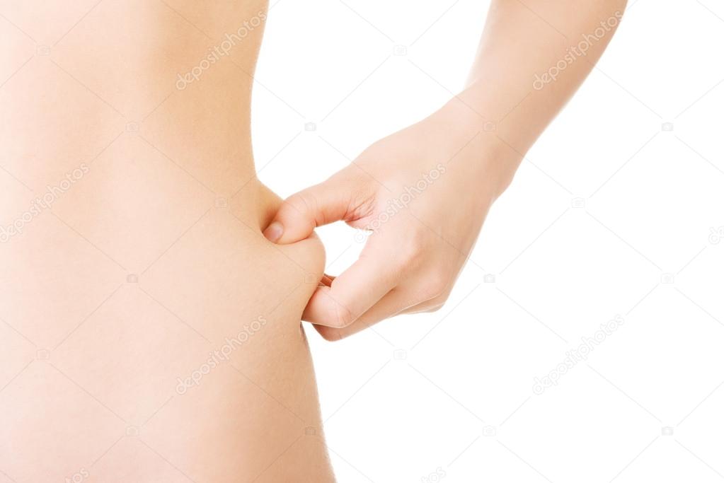 Naked woman's body part, belly, holding fat.