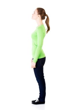 Attractive woman standing and looking up. Side view. clipart