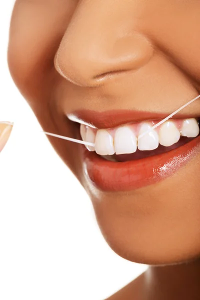 Attractive woman with dental floss. Closeup. — Stock Photo, Image