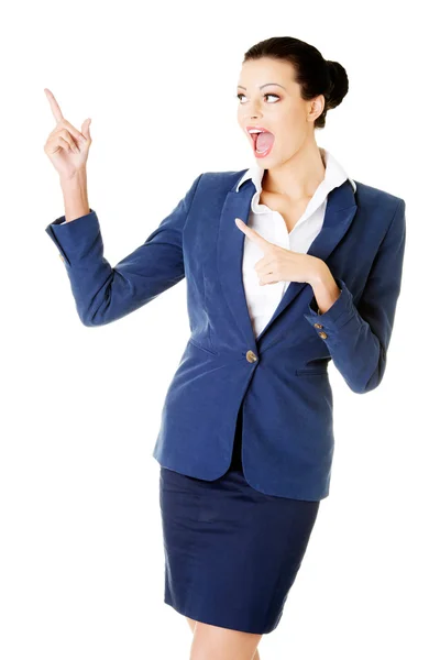 Young female businesswoman pointing up. — Stock Photo, Image