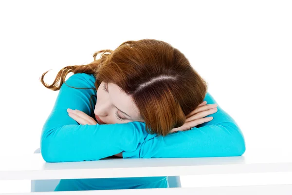 Beautiful casual woman sleeping on a table. — Stock Photo, Image