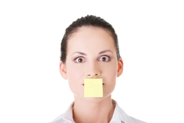 Attractive woman's face with empty card on lips. — Stock Photo, Image