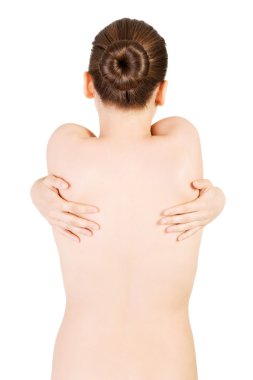 Attractive woman trying to touch both hands on her back. clipart