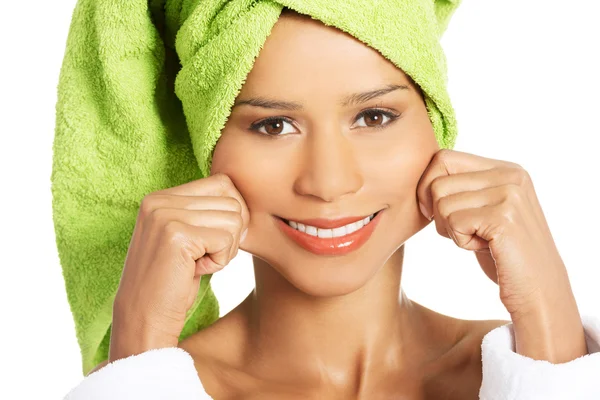 Attractive woman wrapped in towel, holding her mouth in a smile. — Stock Photo, Image